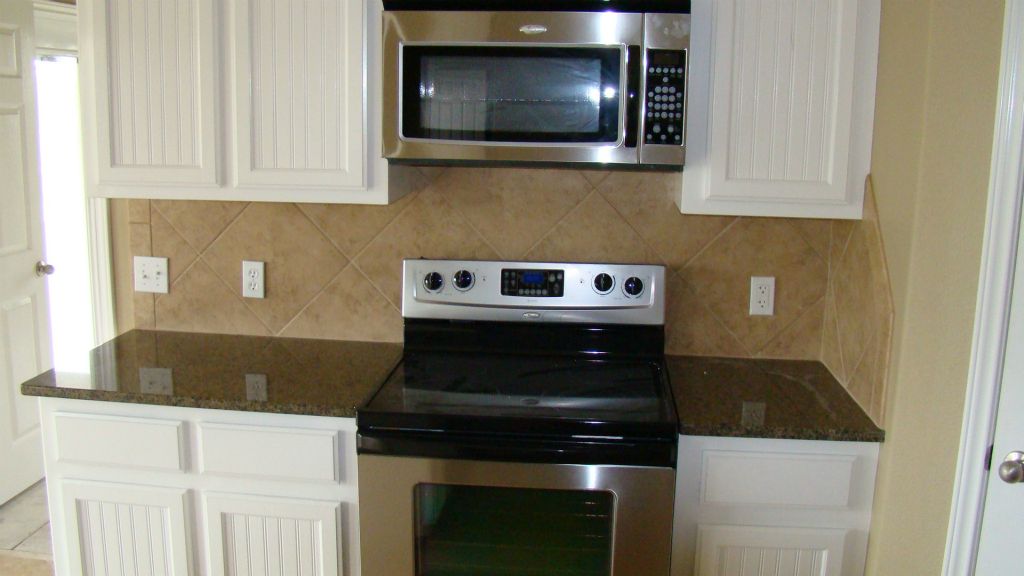 KITCHEN with GRANITE TOPS, SS APPLIANCES, CUSTOM CABINETS
